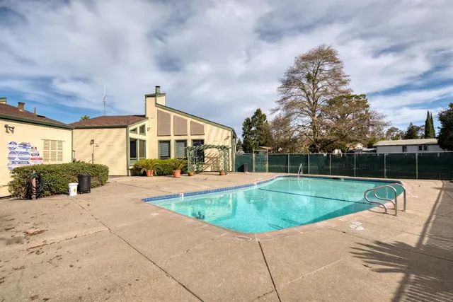a view of a house with swimming pool and sitting area