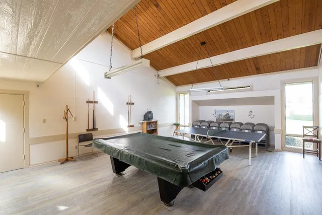 a living room with lots of furniture and paintings on the wall