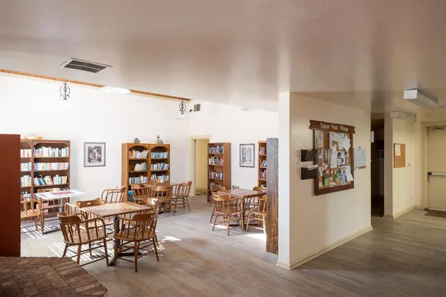a dining room with furniture and wooden floor
