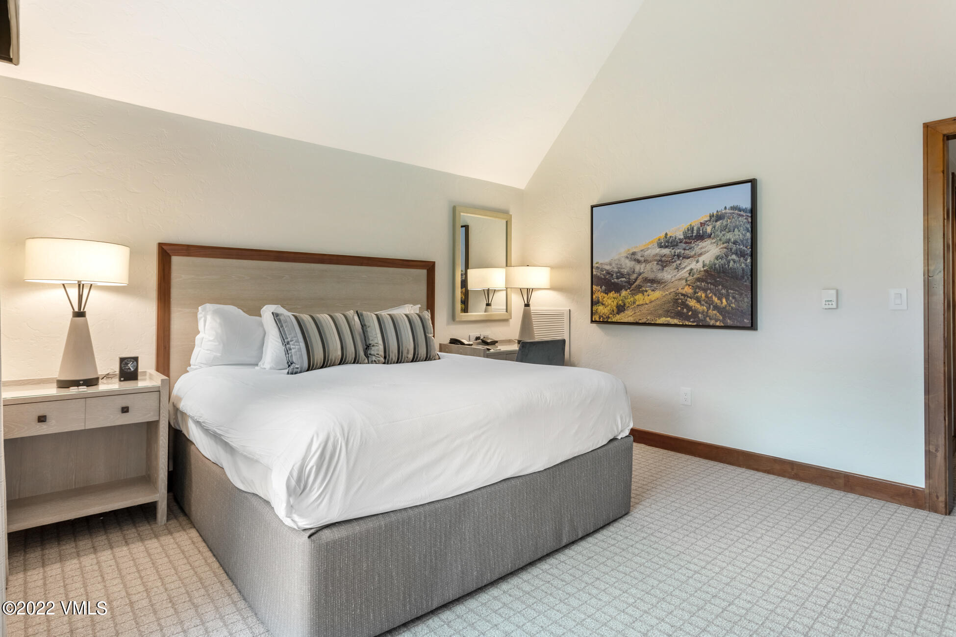 100 Bachelor Ridge Road, Unit 3704 Avon, CO 81620 - Photo 18 of 41 a spacious bedroom with a bed and a night stand