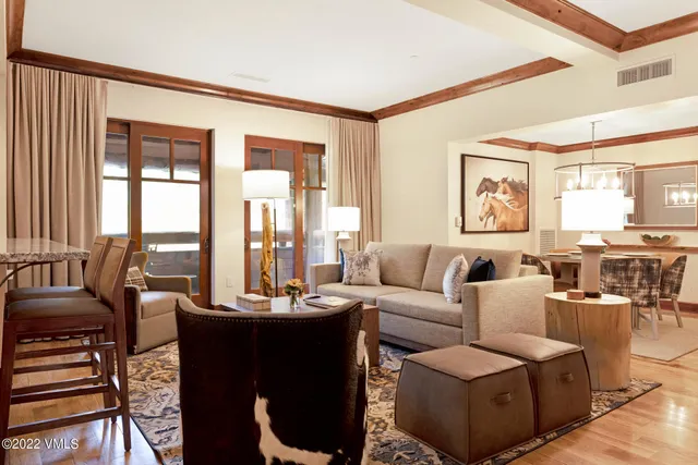 a living room with furniture and large windows