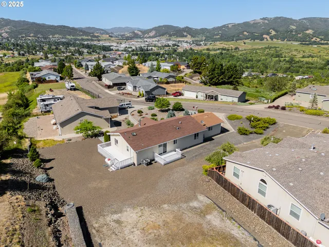 an aerial view of a house with a yard