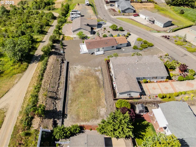 an aerial view of house with a yard