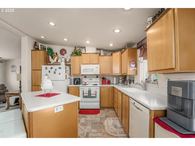 a open kitchen with stainless steel appliances granite countertop a sink dishwasher stove and refrigerator