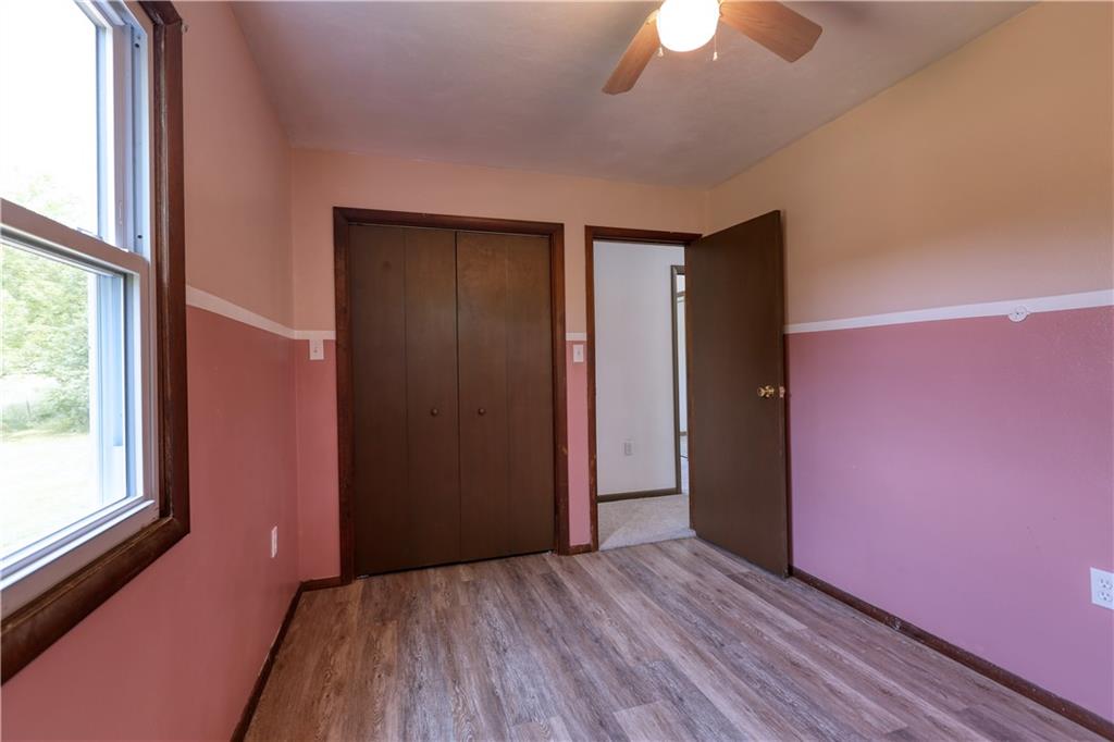 123 Noonen Street Rochester, PA 15074 - Photo 21 of 34 an empty room with wooden floor chandelier fan and windows