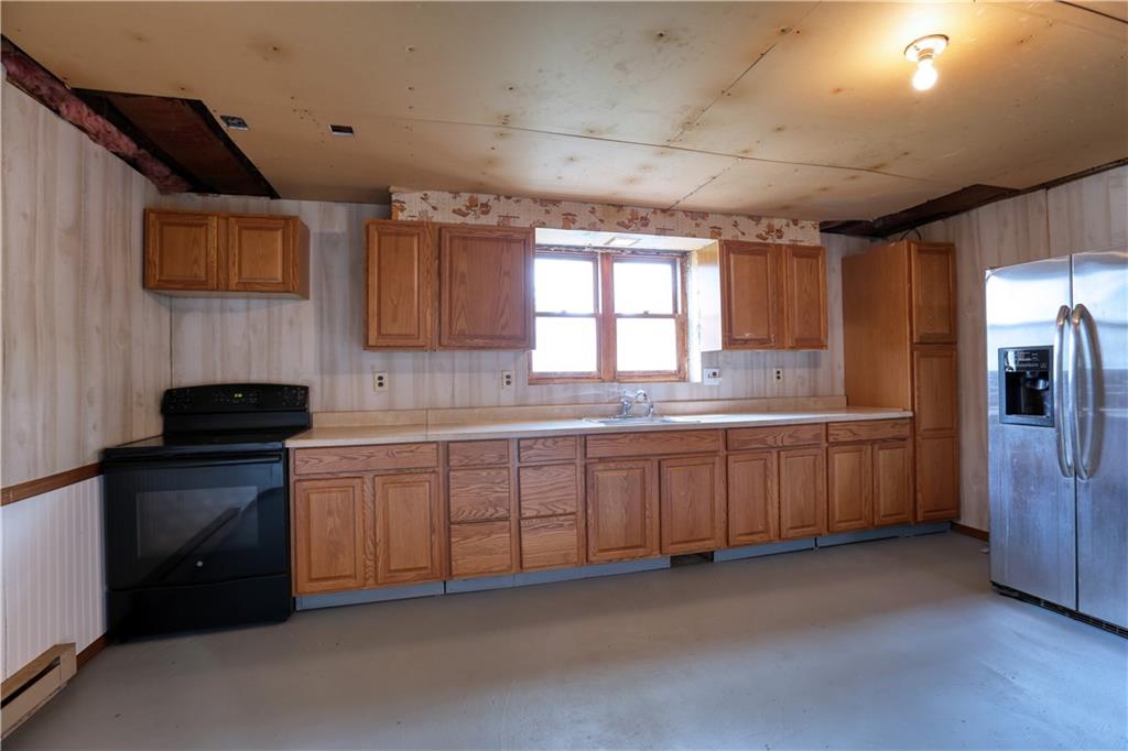 123 Noonen Street Rochester, PA 15074 - Photo 26 of 34 a kitchen with granite countertop a sink stainless steel appliances a counter space and a window