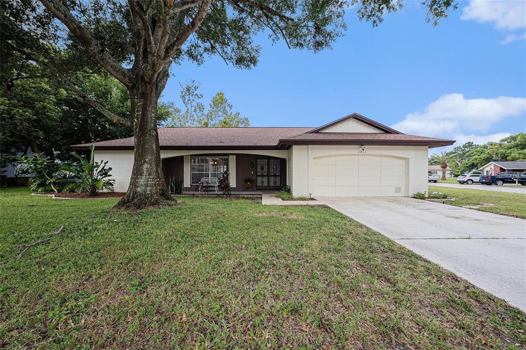 13013 Sawmill Way Hudson, FL 34667 - Photo 1 of 33 a front view of a house with a garden