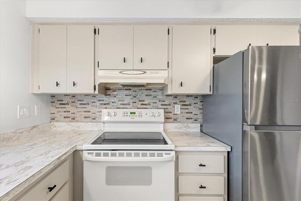 13013 Sawmill Way Hudson, FL 34667 - Photo 16 of 33 a kitchen with appliances cabinets and a counter space