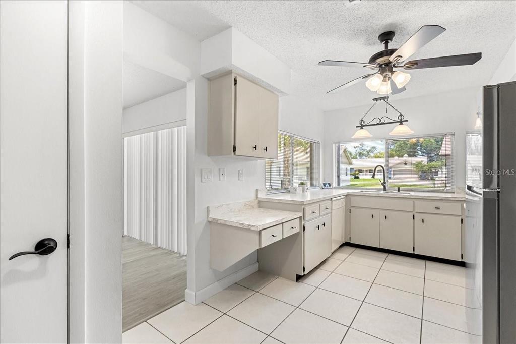 13013 Sawmill Way Hudson, FL 34667 - Photo 20 of 33 a large white kitchen with a window and stainless steel appliances