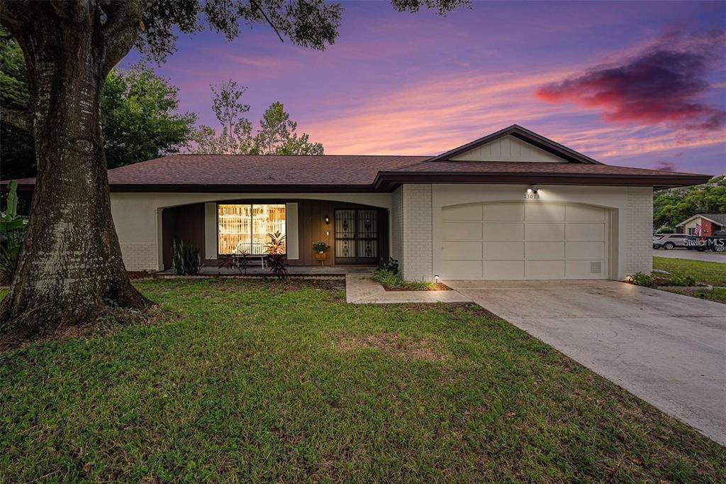 13013 Sawmill Way Hudson, FL 34667 - Photo 2 of 33 a front view of a house with a yard and garage