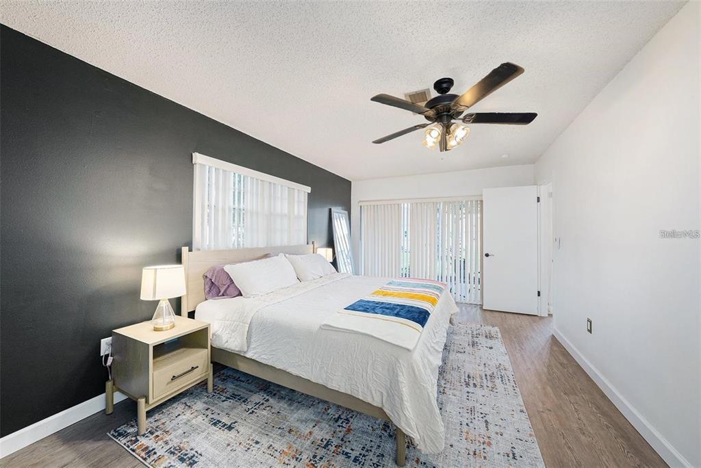 13013 Sawmill Way Hudson, FL 34667 - Photo 23 of 33 a bedroom with a bed and a chandelier