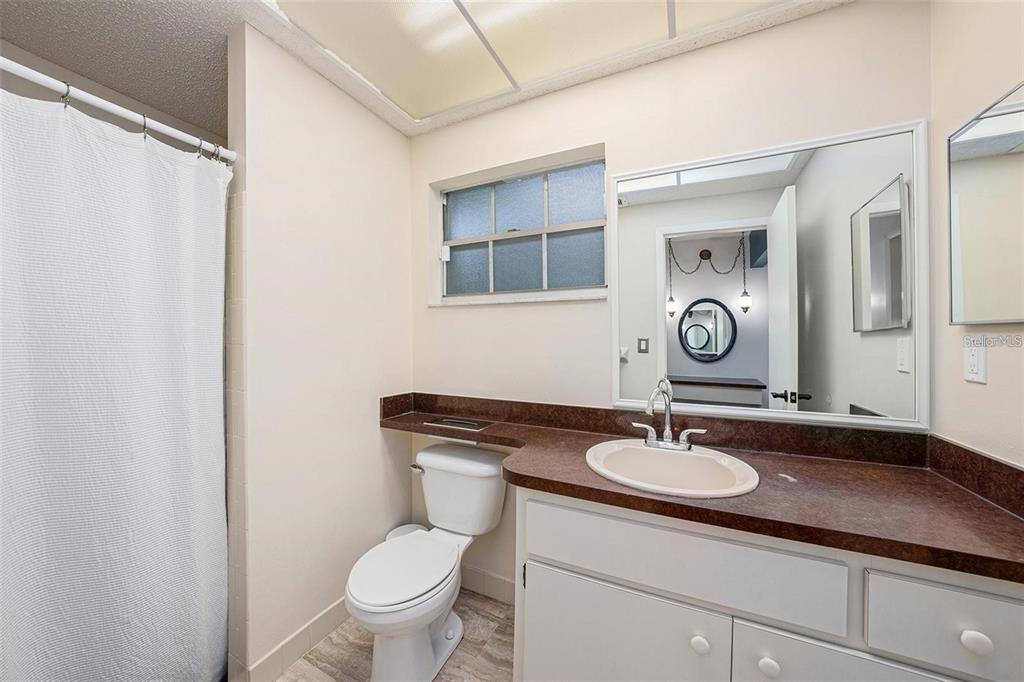 13013 Sawmill Way Hudson, FL 34667 - Photo 27 of 33 a toilet sitting next to a bathroom sink and mirror