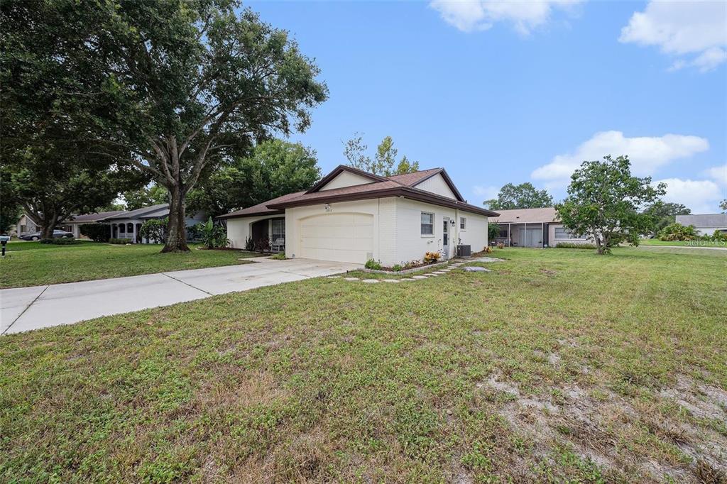 13013 Sawmill Way Hudson, FL 34667 - Photo 31 of 33 a front view of a house with garden