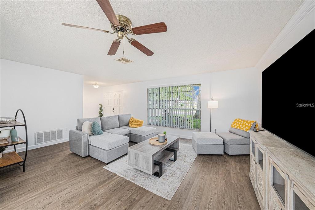 13013 Sawmill Way Hudson, FL 34667 - Photo 6 of 33 a living room with furniture and a window