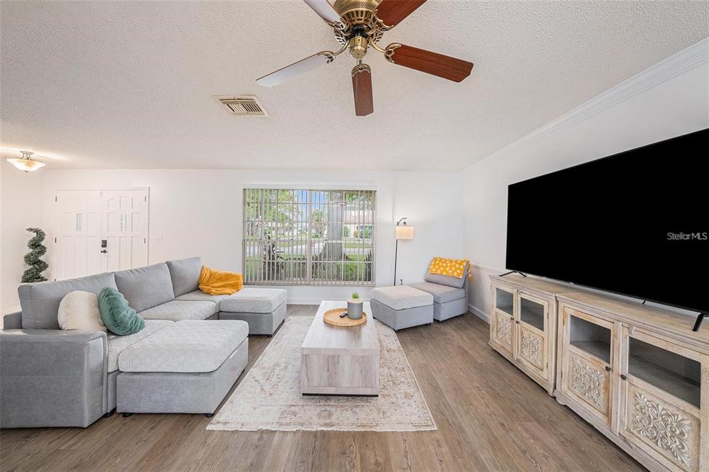 13013 Sawmill Way Hudson, FL 34667 - Photo 7 of 33 a living room with furniture and a flat screen tv