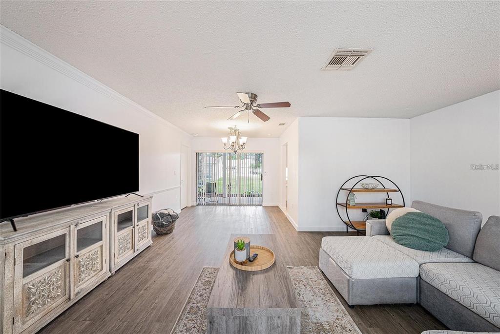 13013 Sawmill Way Hudson, FL 34667 - Photo 8 of 33 a living room with furniture and a flat screen tv