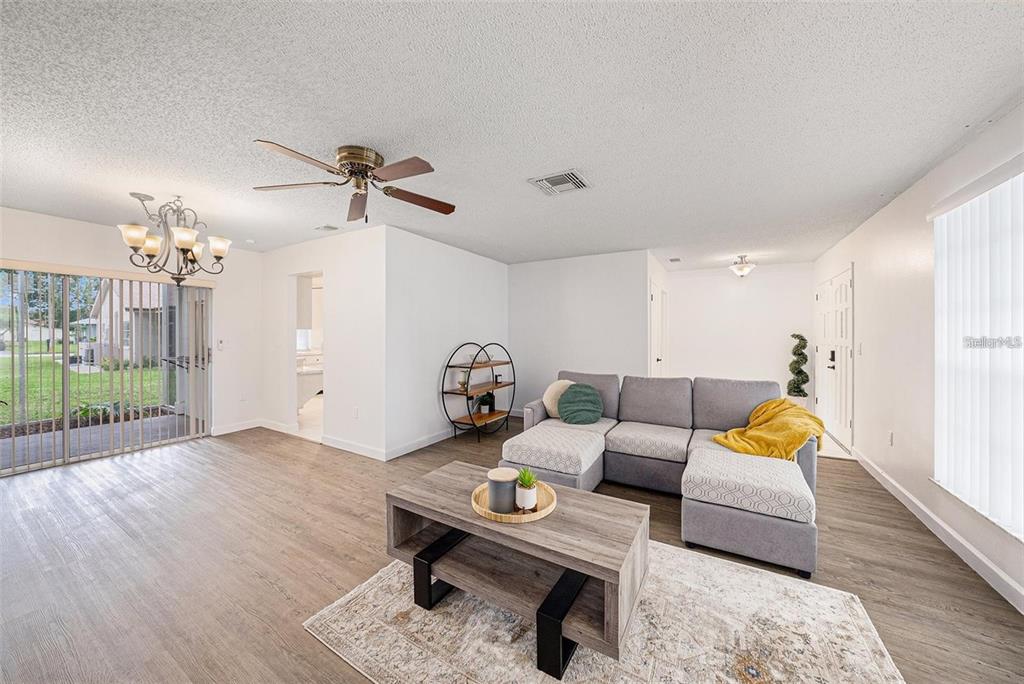 13013 Sawmill Way Hudson, FL 34667 - Photo 10 of 33 a living room with furniture and wooden floor