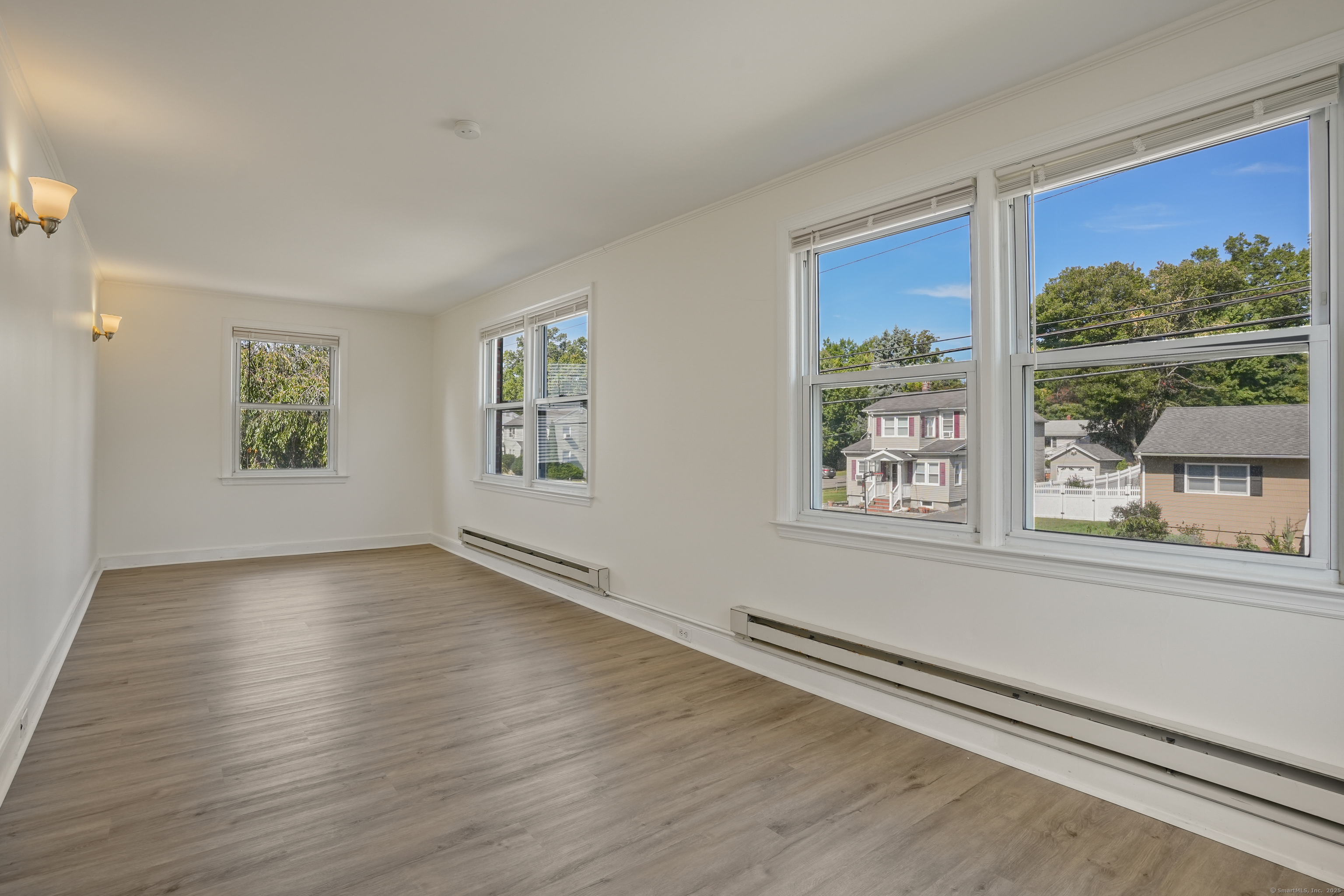 221 Hunyadi Avenue Fairfield, CT 06824 - Photo 25 of 39 an empty room with wooden floor and windows