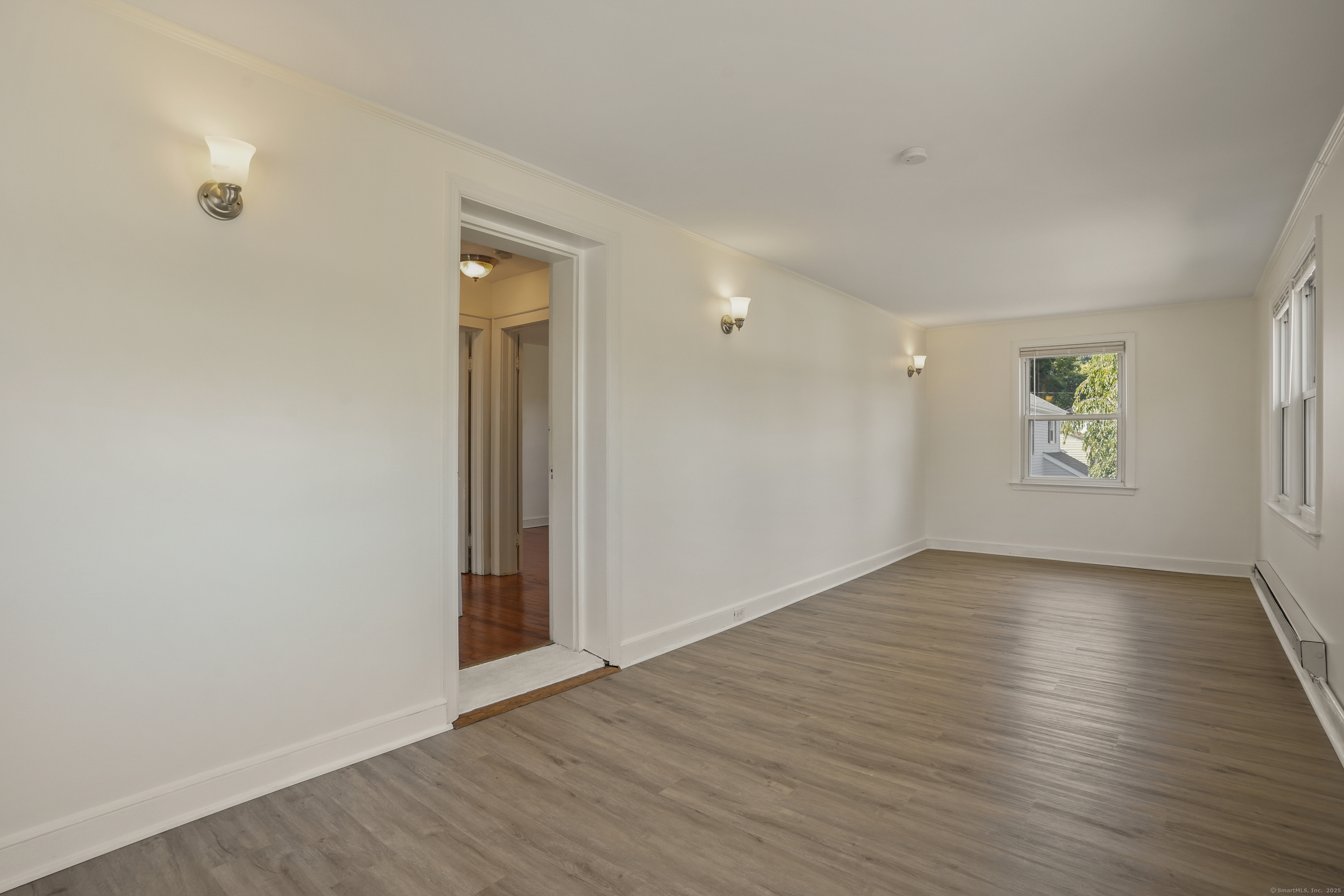 221 Hunyadi Avenue Fairfield, CT 06824 - Photo 26 of 39 an empty room with wooden floor and windows