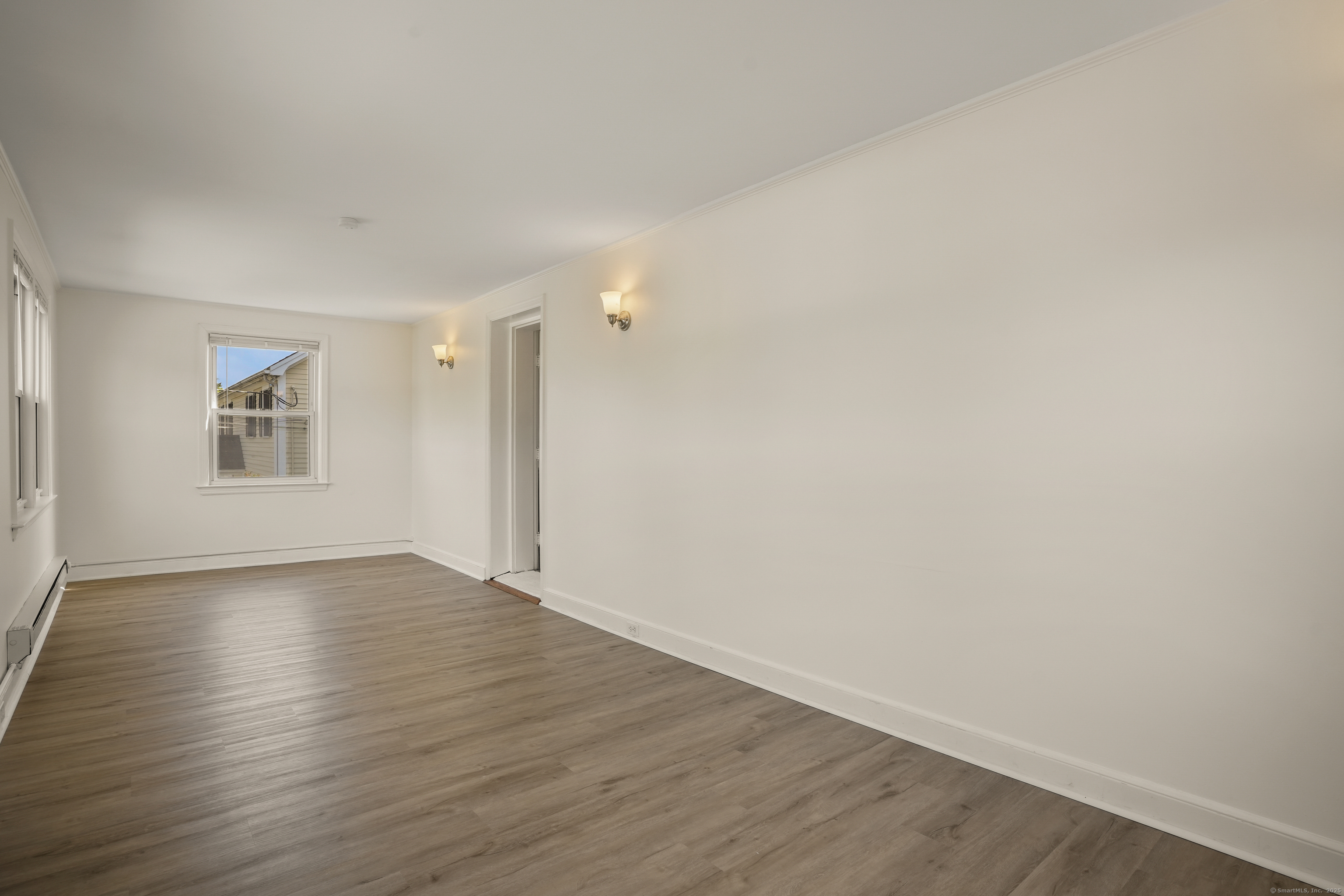 221 Hunyadi Avenue Fairfield, CT 06824 - Photo 28 of 39 a view of an empty room with wooden floor and a window
