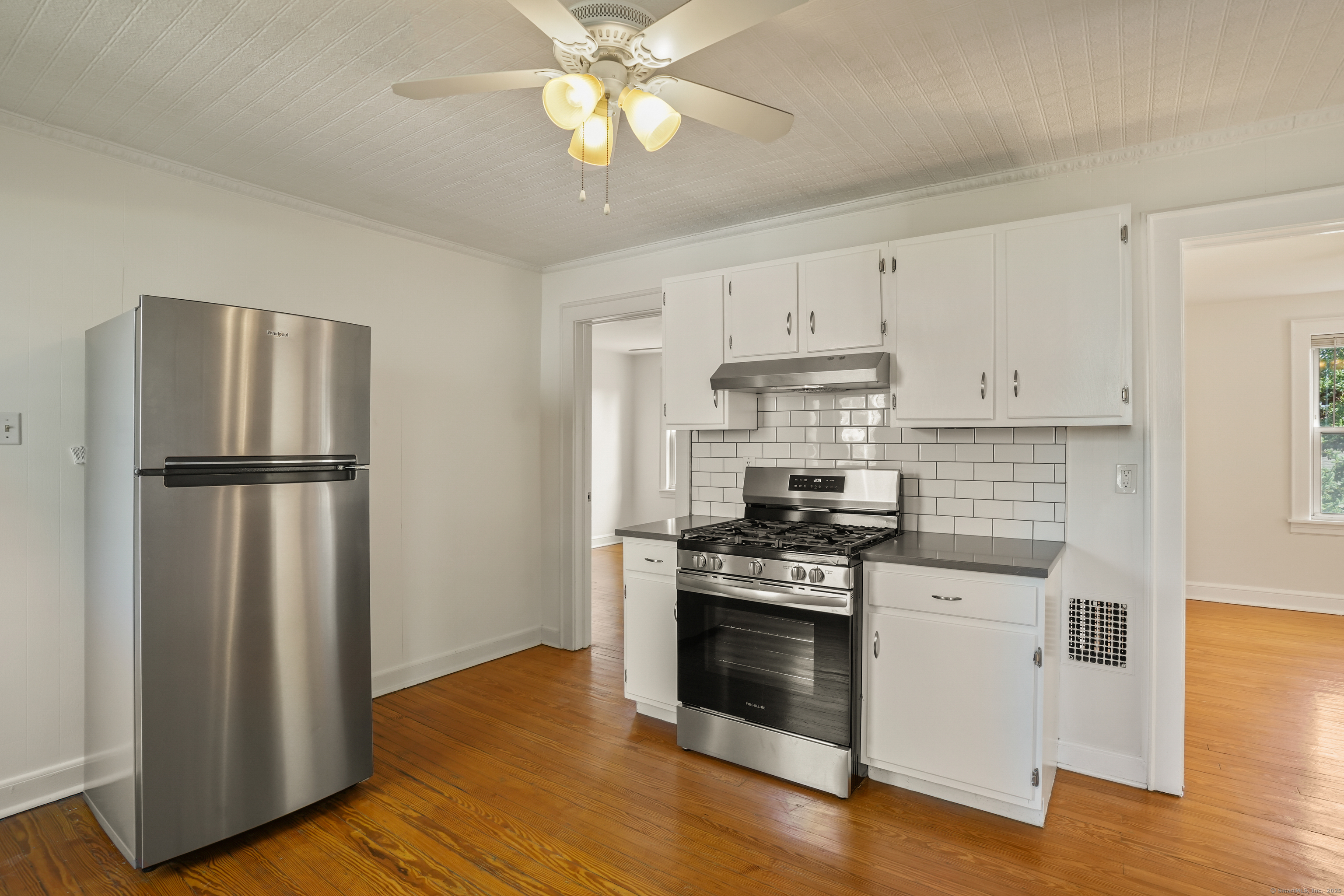 221 Hunyadi Avenue Fairfield, CT 06824 - Photo 30 of 39 a kitchen with stainless steel appliances granite countertop a refrigerator a stove a sink and a granite counter tops