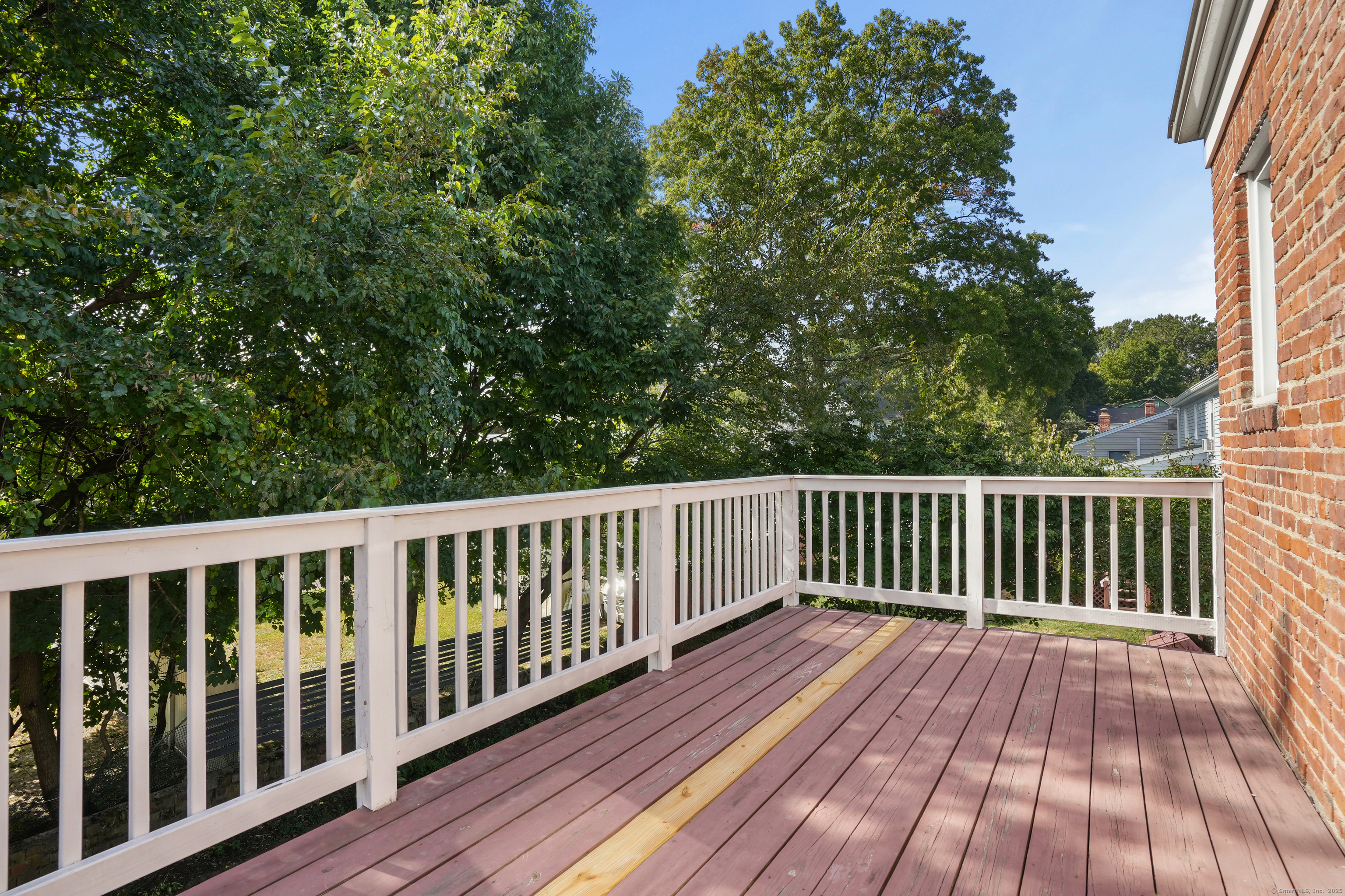 221 Hunyadi Avenue Fairfield, CT 06824 - Photo 35 of 39 a balcony with wooden floor and fence