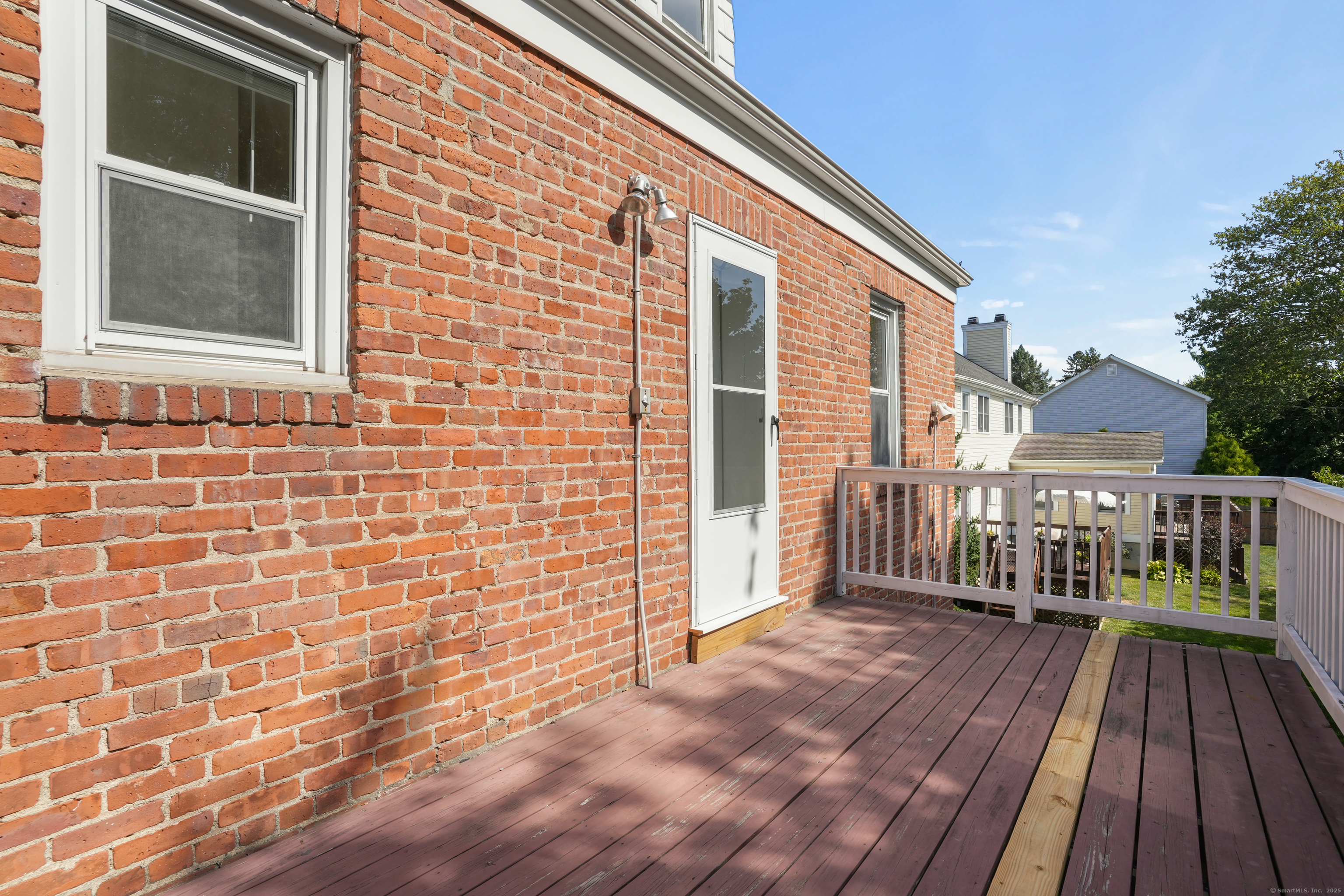 221 Hunyadi Avenue Fairfield, CT 06824 - Photo 36 of 39 a view of a brick house with a balcony