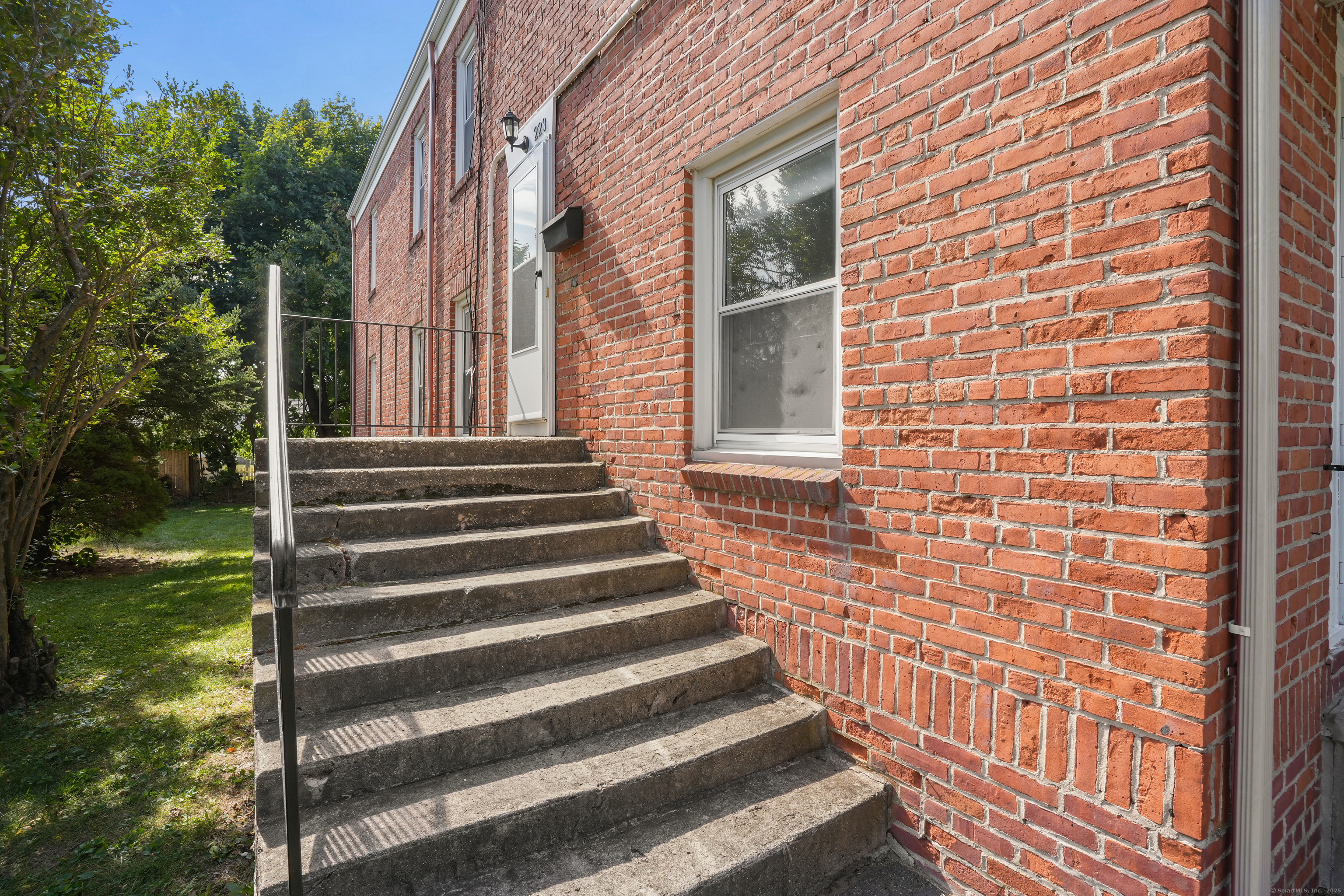 221 Hunyadi Avenue Fairfield, CT 06824 - Photo 38 of 39 a view of a brick house with a yard