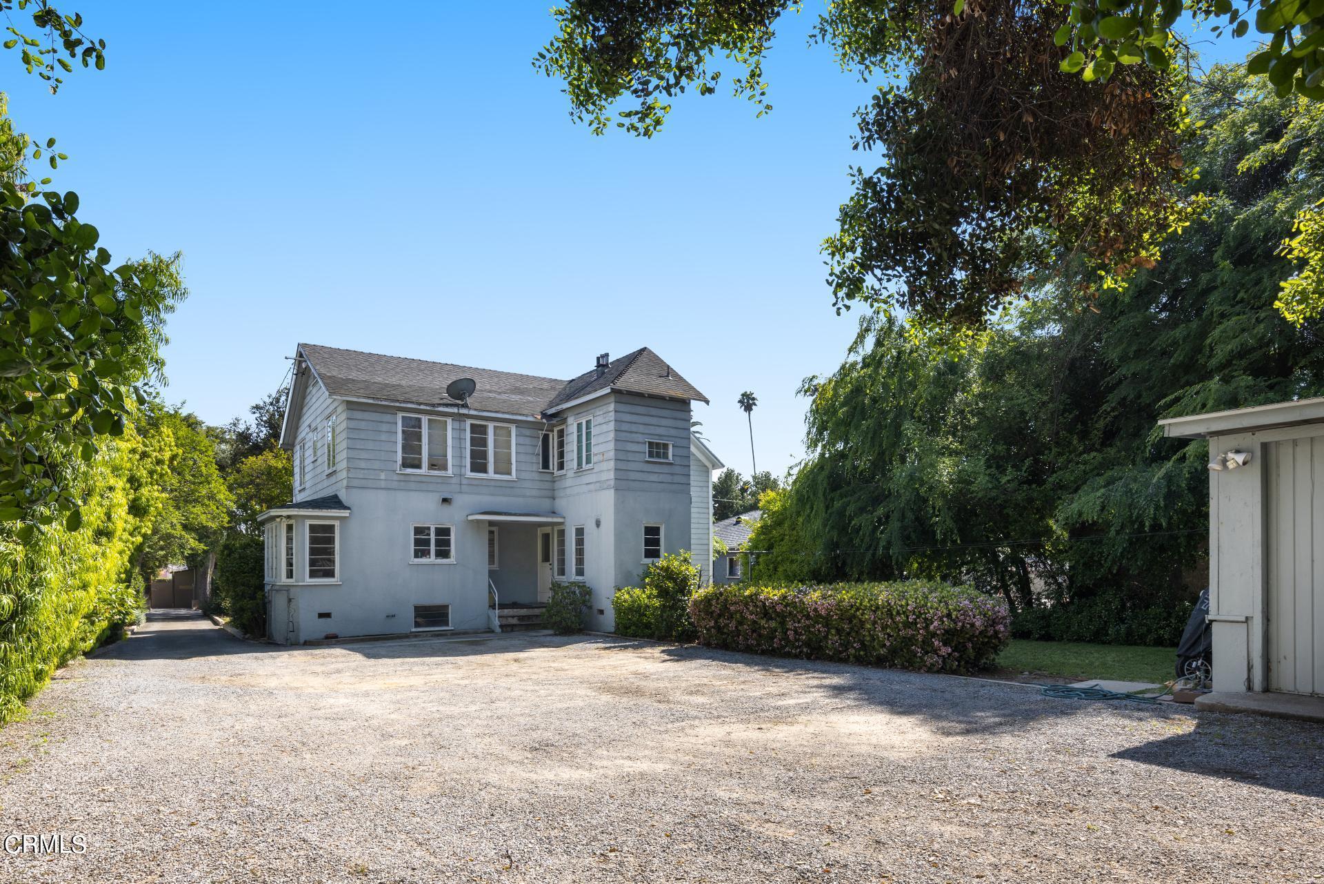 1055 Locust Street Pasadena, CA 91106 - Photo 3 of 14 a front view of a house with a yard and garage