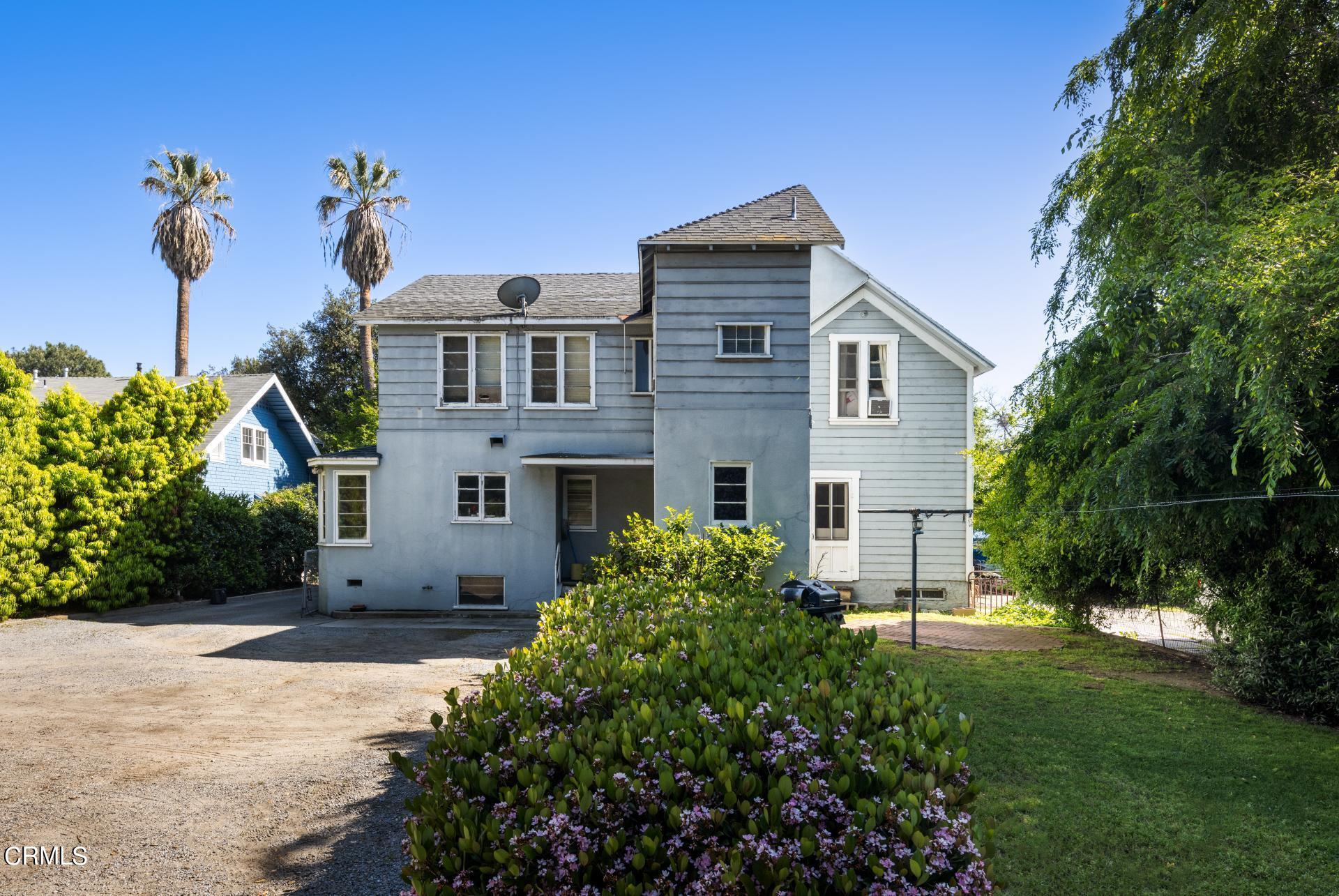 1055 Locust Street Pasadena, CA 91106 - Photo 5 of 14 a front view of a house with a yard