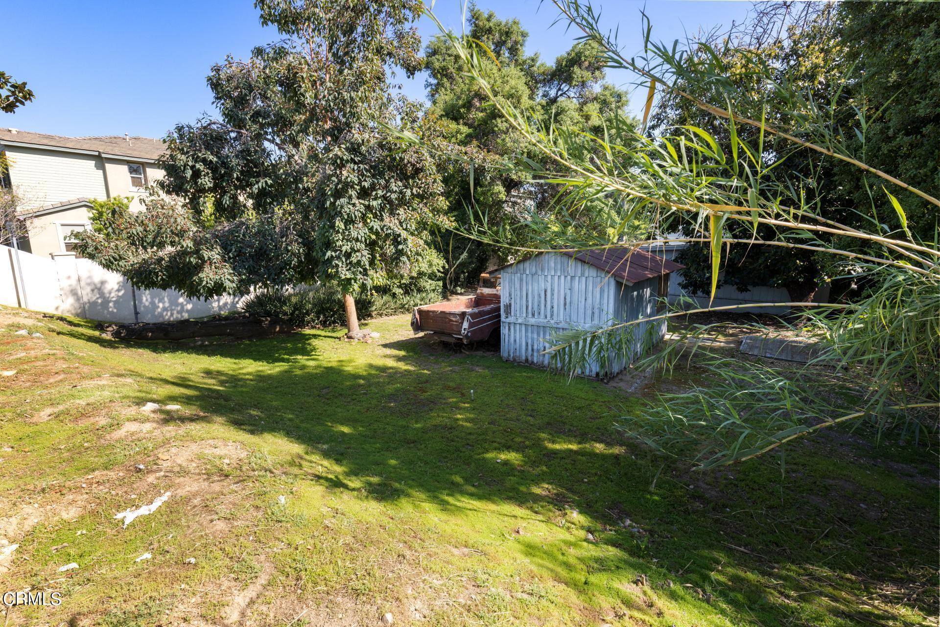 1055 Locust Street Pasadena, CA 91106 - Photo 7 of 14 a backyard of a house with table and chairs