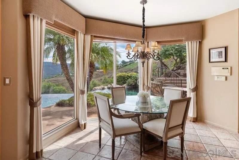 3674 Via Calabria Escondido, CA 92025 - Photo 13 of 49 a dining room with furniture large windows and a chandelier