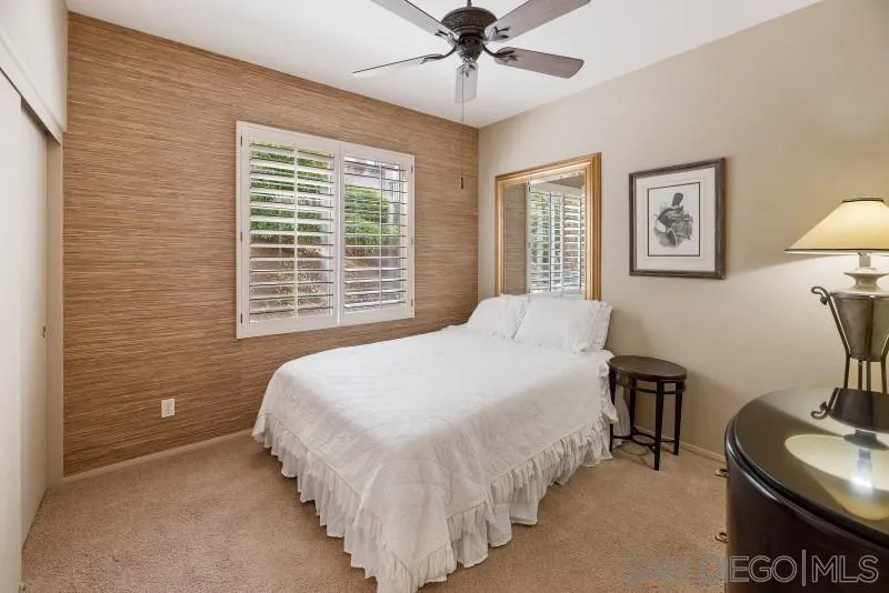 3674 Via Calabria Escondido, CA 92025 - Photo 20 of 49 a bedroom with a bed and a lamp on dresser with wooden floor