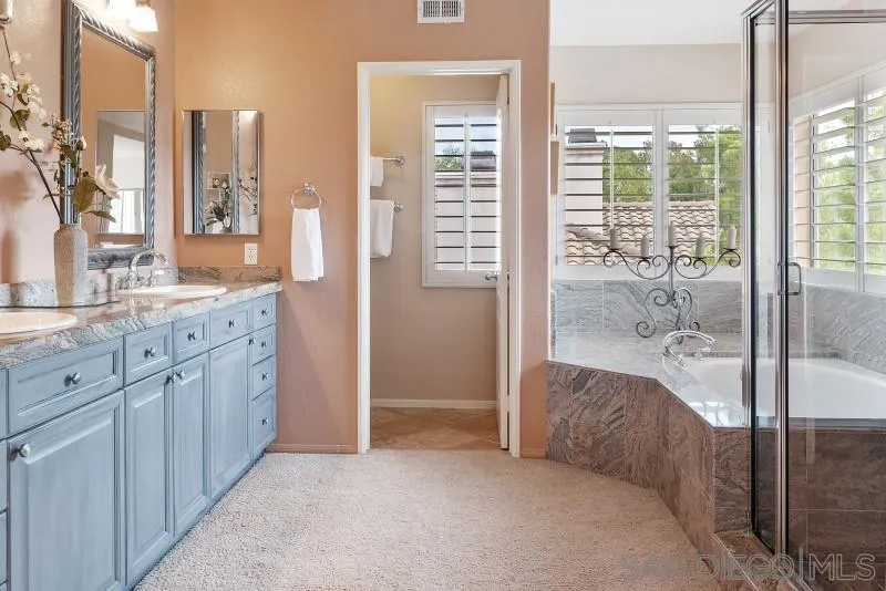 3674 Via Calabria Escondido, CA 92025 - Photo 27 of 49 a en suite bathroom with a granite countertop sink and a mirror
