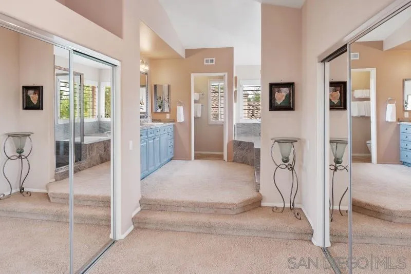 3674 Via Calabria Escondido, CA 92025 - Photo 28 of 49 a spacious bedroom with a bed and glass door