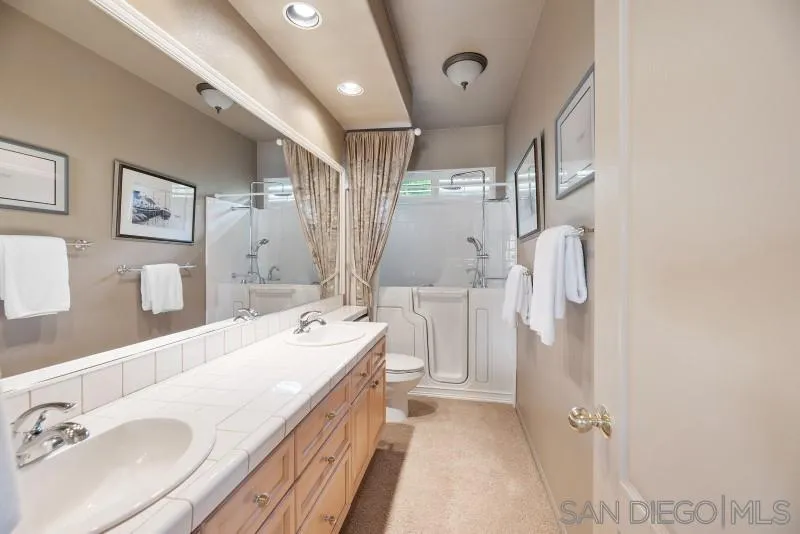 3674 Via Calabria Escondido, CA 92025 - Photo 32 of 49 a bathroom with a double vanity sink mirror and shower