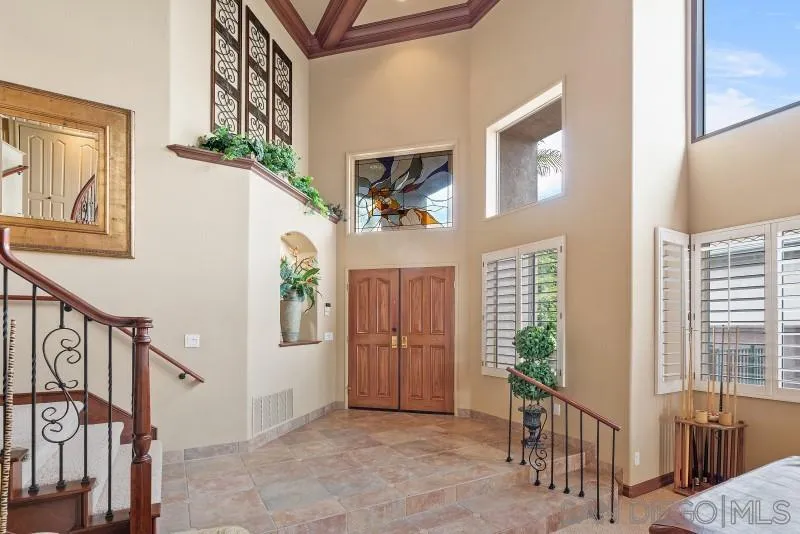 3674 Via Calabria Escondido, CA 92025 - Photo 7 of 49 a view of a hallway to a livingroom with wooden floor and windows