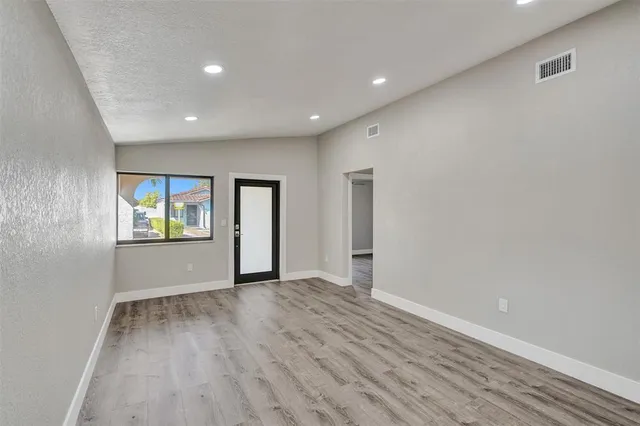 wooden floor in an empty room with a window