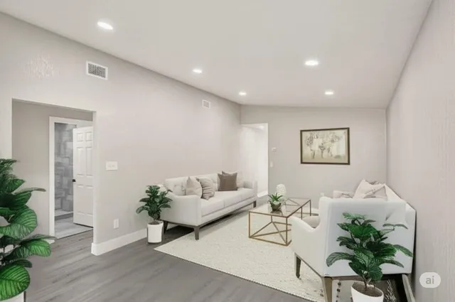 a living room with furniture and potted plant