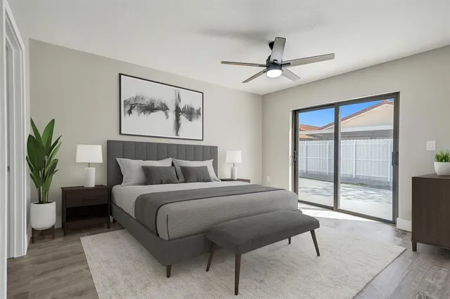 a bedroom with a large bed and a chandelier