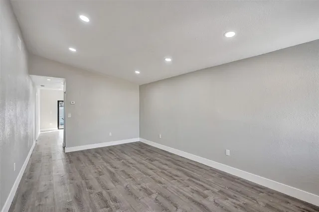a view of room with wooden floor