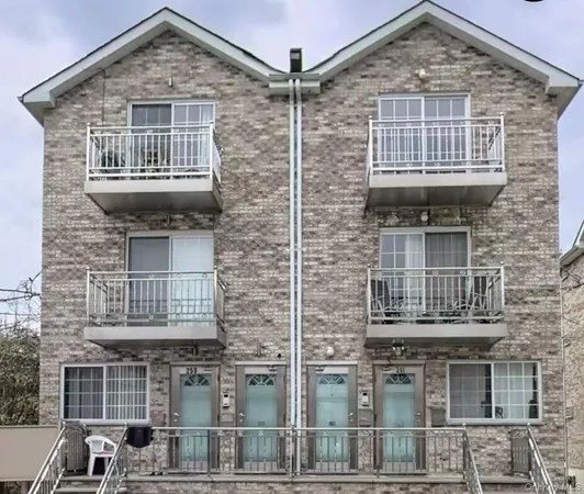 a front view of a house with a brick wall