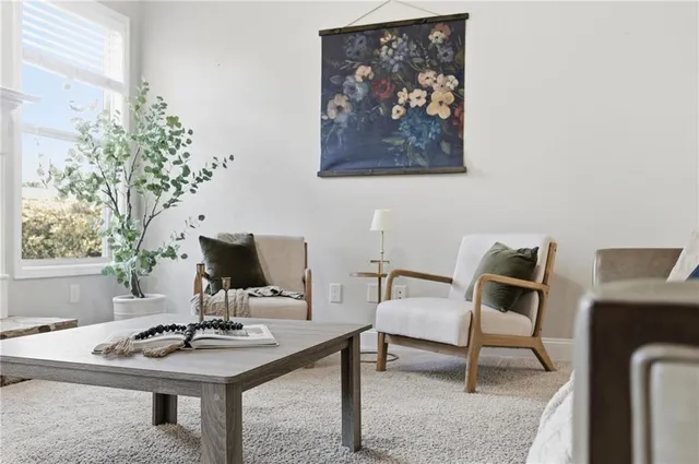 a kitchen with stainless steel appliances granite countertop a table chairs sink refrigerator and cabinets