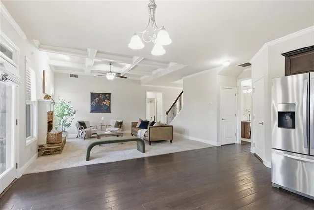 a kitchen with granite countertop stainless steel appliances a sink stove and cabinets