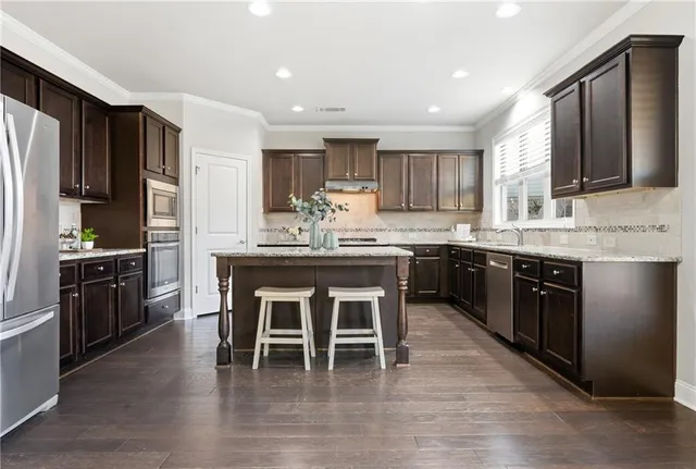 a kitchen with granite countertop a stove and a cabinets