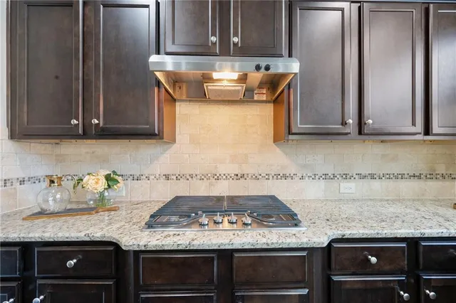 a living room with furniture a lamp and a potted plant