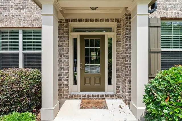a front view of a house with a garden