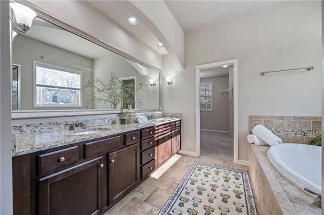 a bathroom with a double vanity sink and a mirror