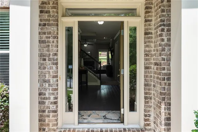a dining room with furniture a large window and wooden floor
