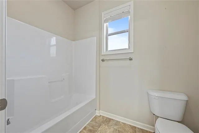 a roof deck with table and chairs